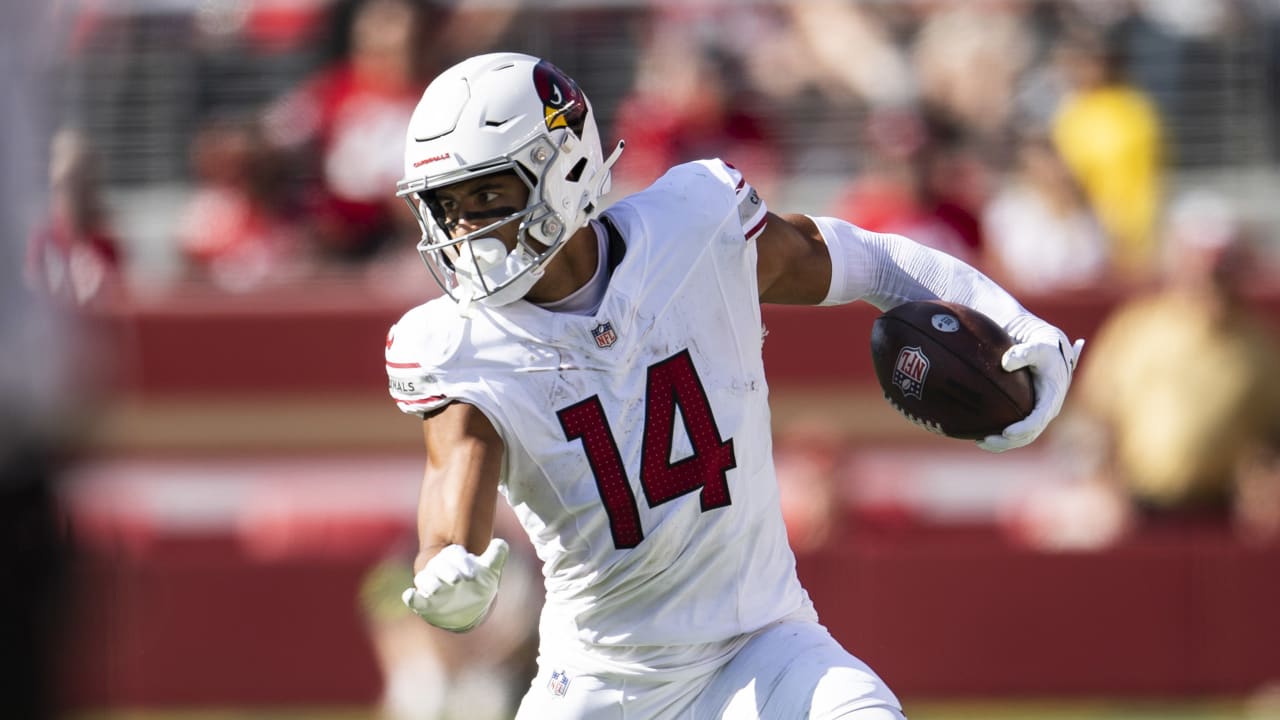 michael wilson carrying the football after a catch